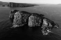 Visscher Island is a dolerite outcrop facing the Tasman sea.

Cape Frederick Hendrick is in the background.